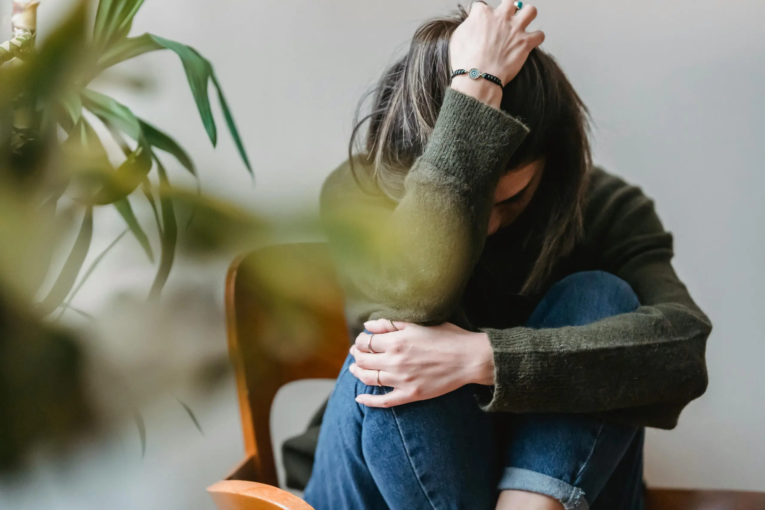 woman frustrated by difficulty making decisions anxiety in chair